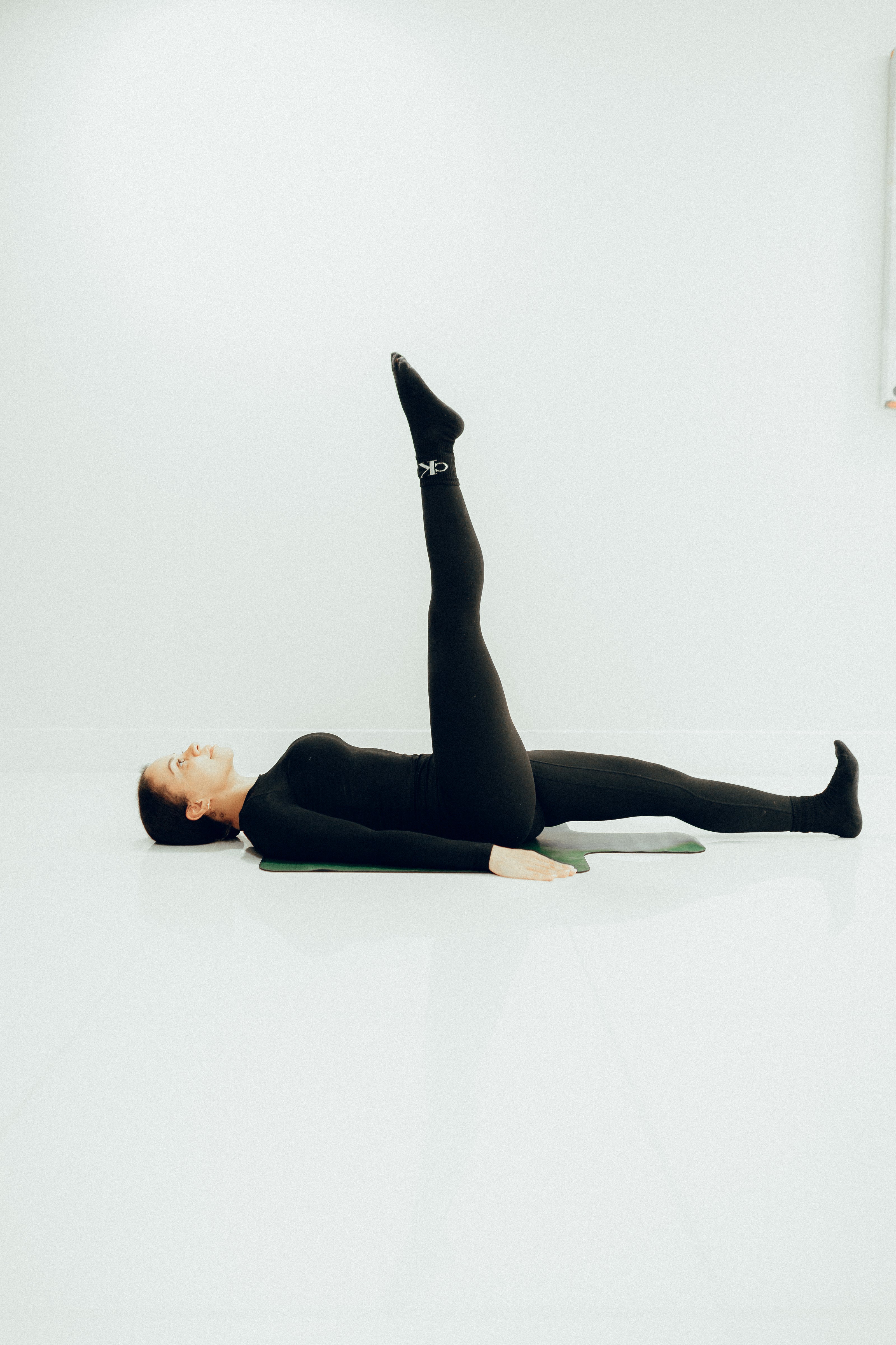 Top London Celebrity Trainer & Pilates Instructor  performing the Classical Stott Pilates One Leg Circle 