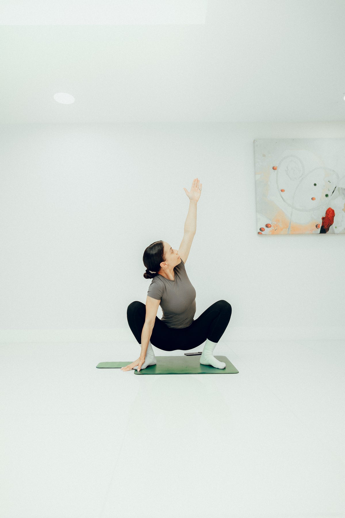Aimee Victoria Long, top London celebrity trainer demonstrating a mat Pilates exercise in a private studio
